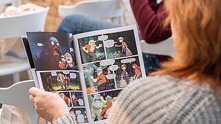 Eine Frau liest einen Comic.