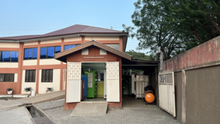 Haus mit geöffnetem Tor zu Anlagenraum